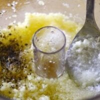 Garlic with salt, pepper, and oil in food processor