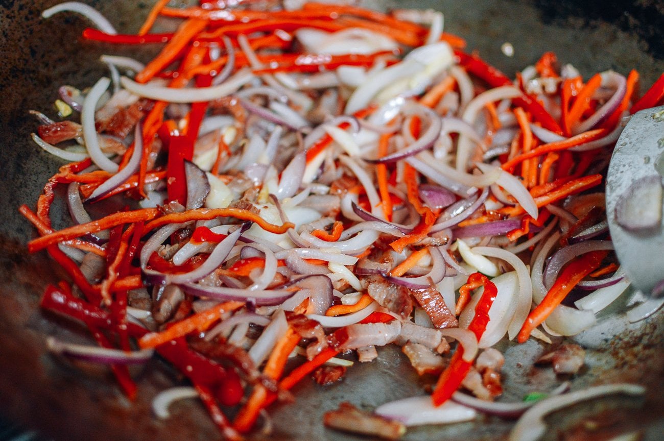 peppers, onions and char siu in wok