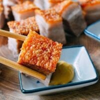 Dipping Cantonese Roast Pork Belly in hot mustard