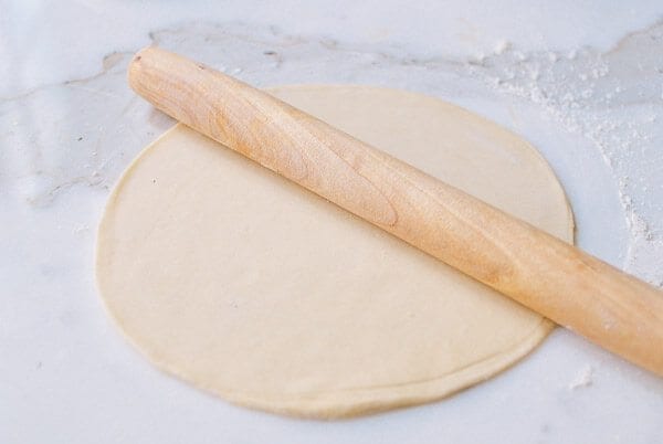 rolling dough into large circle for mandarin pancakes