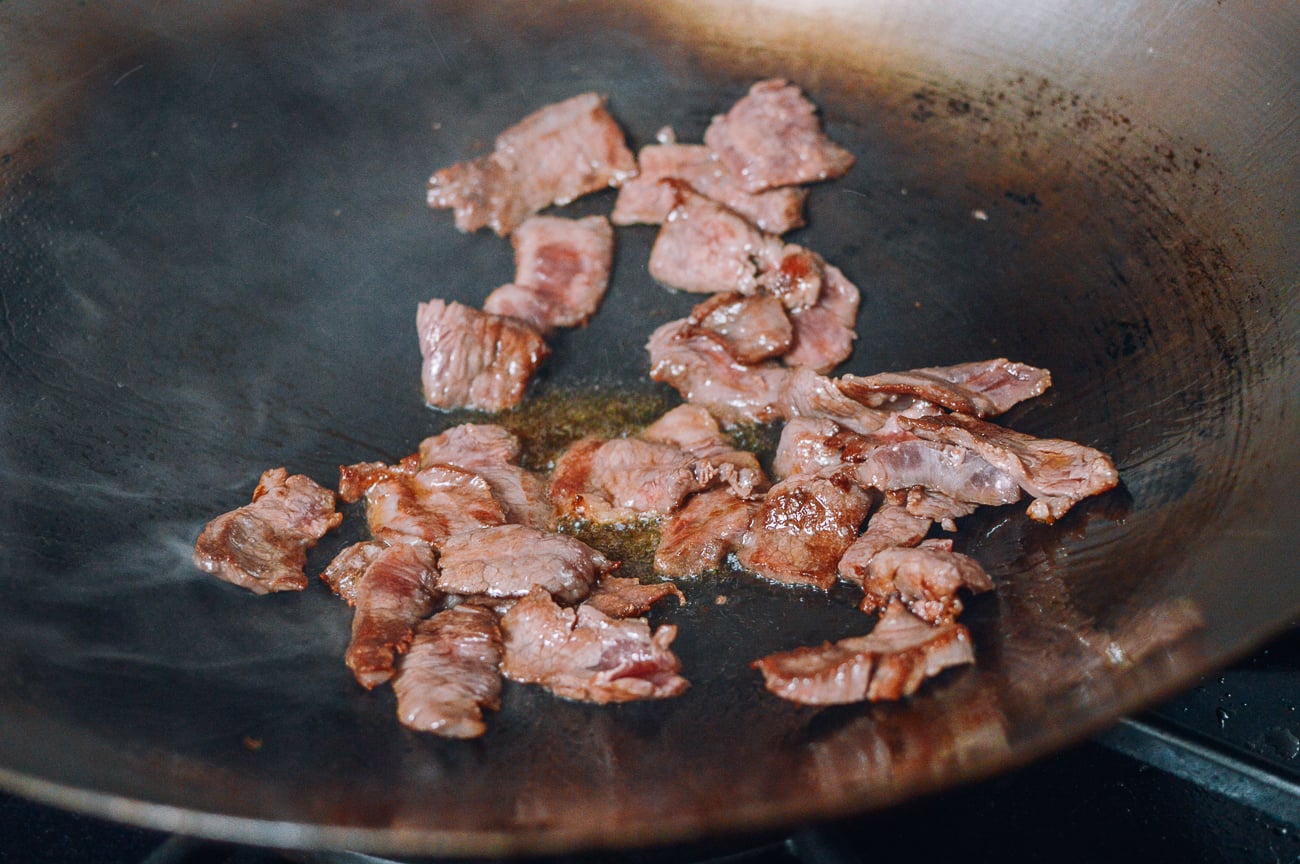 seared beef slices in wok