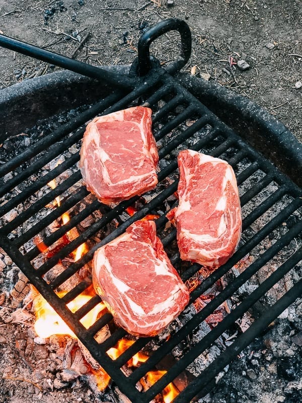 Grilling steak on a fire ring in campground, jcghk.dfhdjkvfj.cf