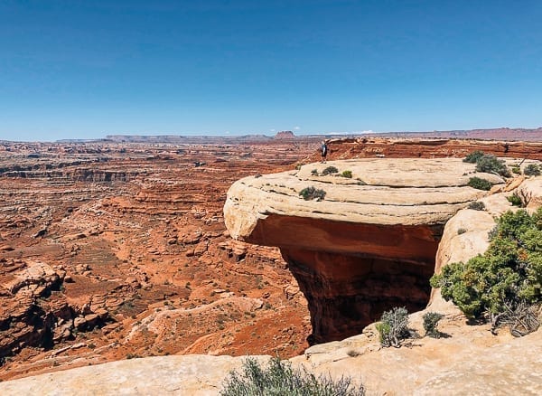 scenic view of hiker near white crack on White rim trail in Canyonlands by jcghk.dfhdjkvfj.cf