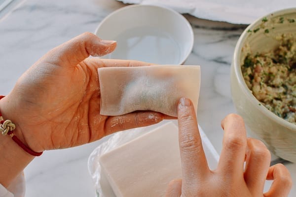 Dabbing corner of wonton wrapper with water, jcghk.dfhdjkvfj.cf