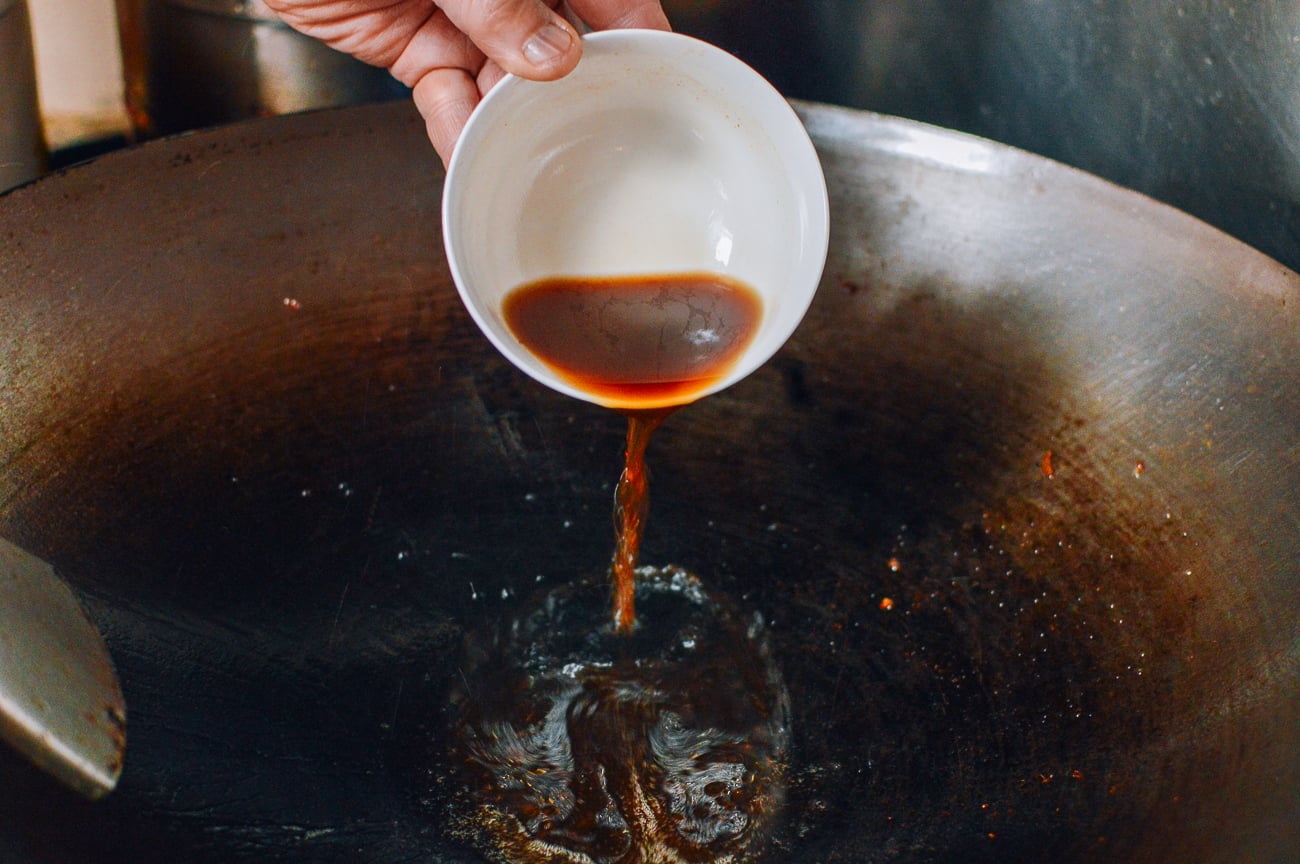 adding sauce mixture to wok