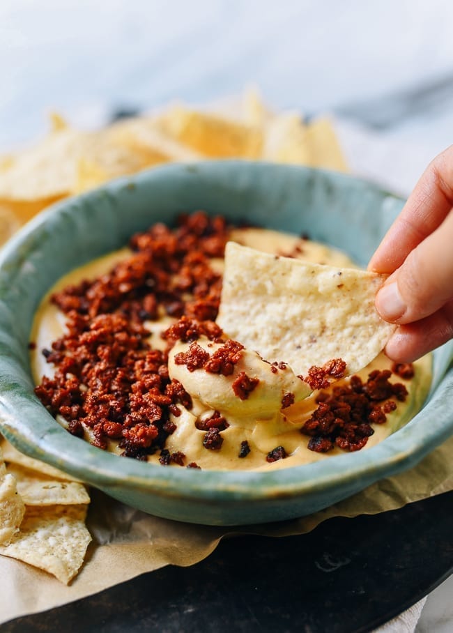 Dipping chip into vegan queso, jcghk.dfhdjkvfj.cf