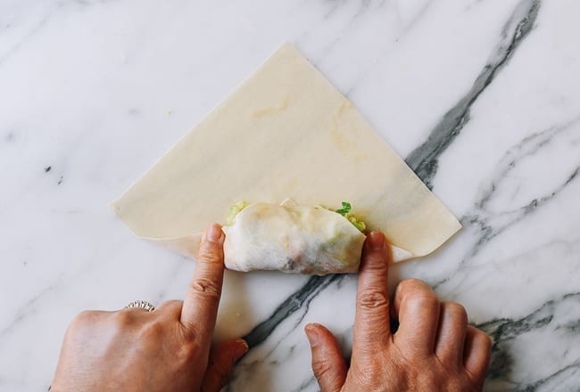 Pressing down egg roll wrapper on both sides of filling, jcghk.dfhdjkvfj.cf