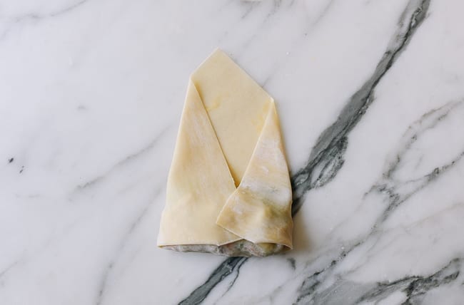 Folding both sides of egg roll wrapper into the middle, jcghk.dfhdjkvfj.cf