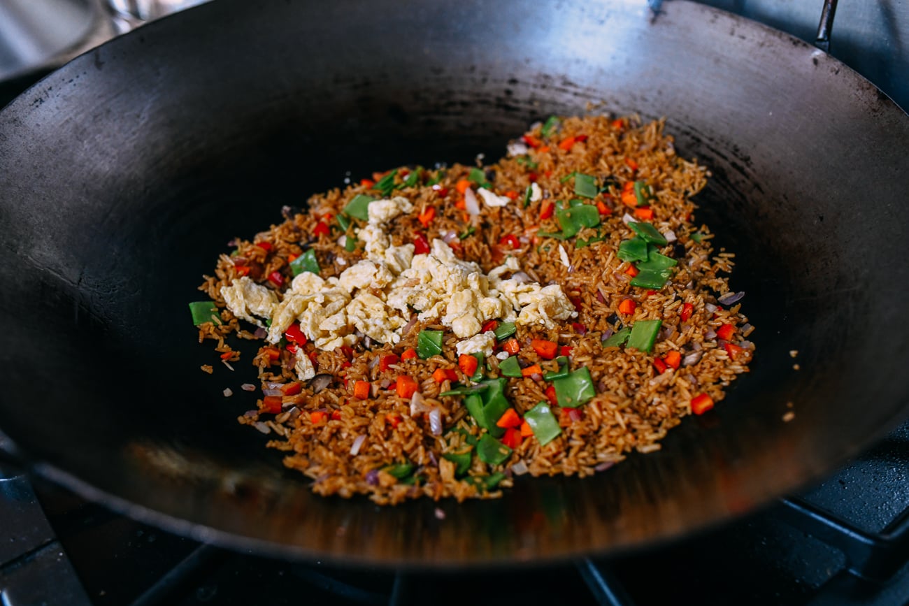Adding eggs to vegetable fried rice