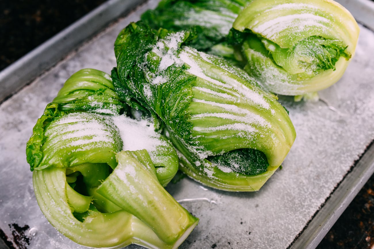 Salt sprinkled over blanched mustard greens