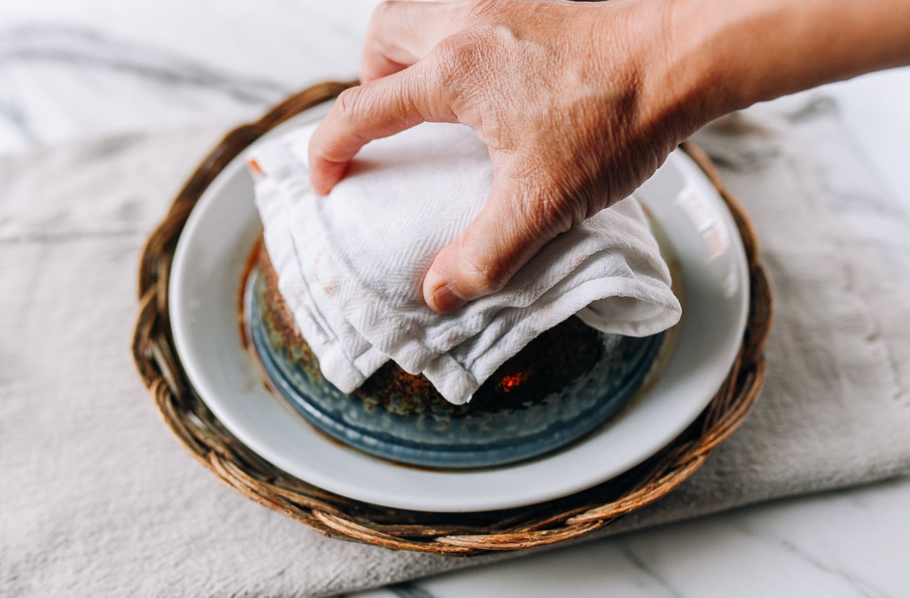 Grabbing hot bowl with a towel