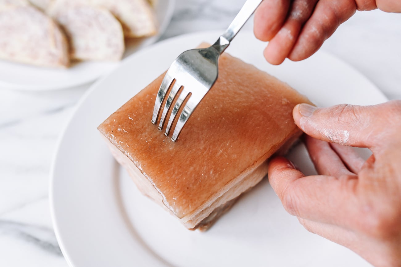 Piercing pork belly skin with fork