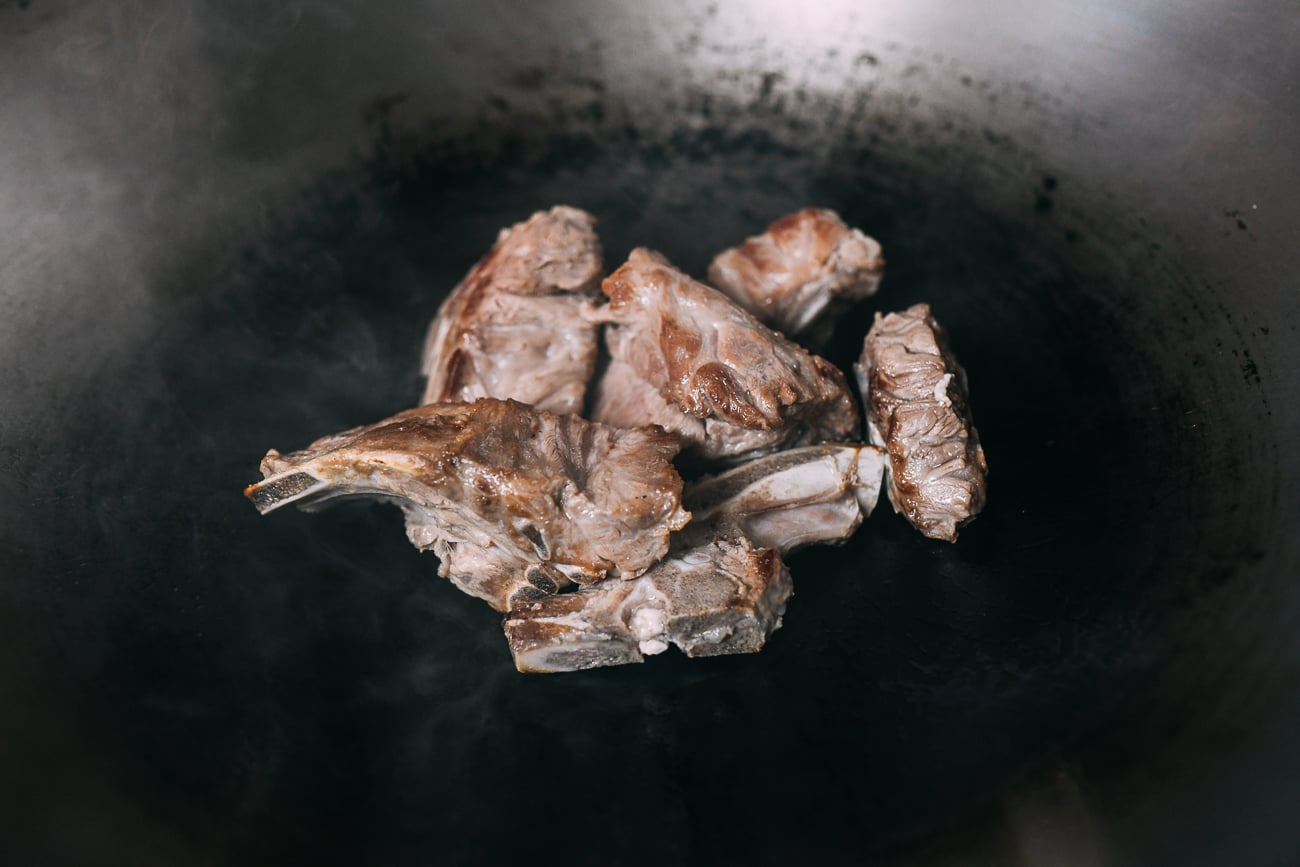 Browning pork bones in wok
