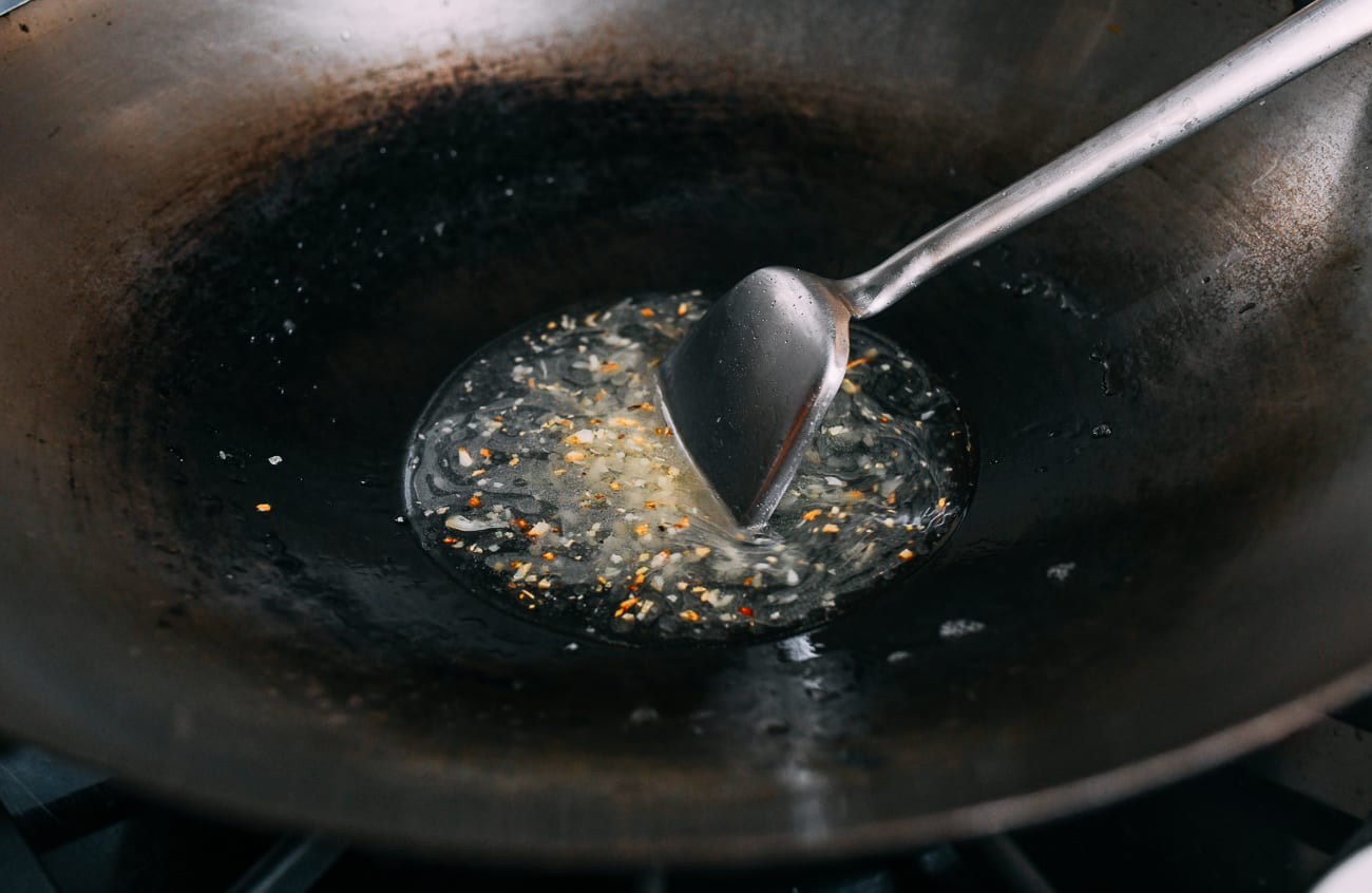 Water, ginger, and garlic in wok