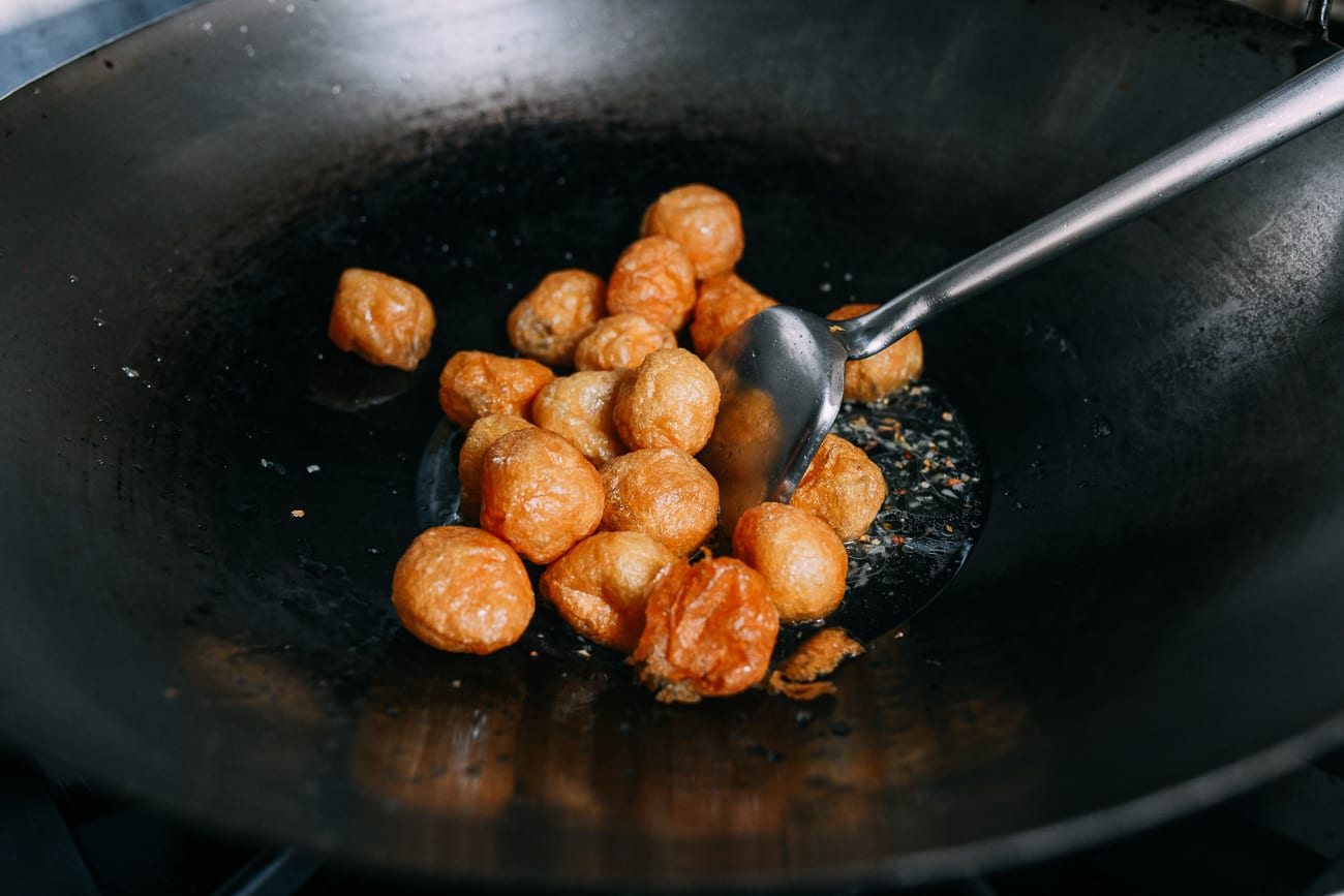 Adding seitan puffs to wok