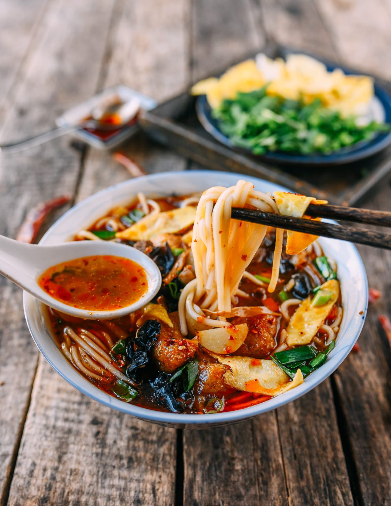 Eating saozi mian with Chinese soup spoon and chopsticks