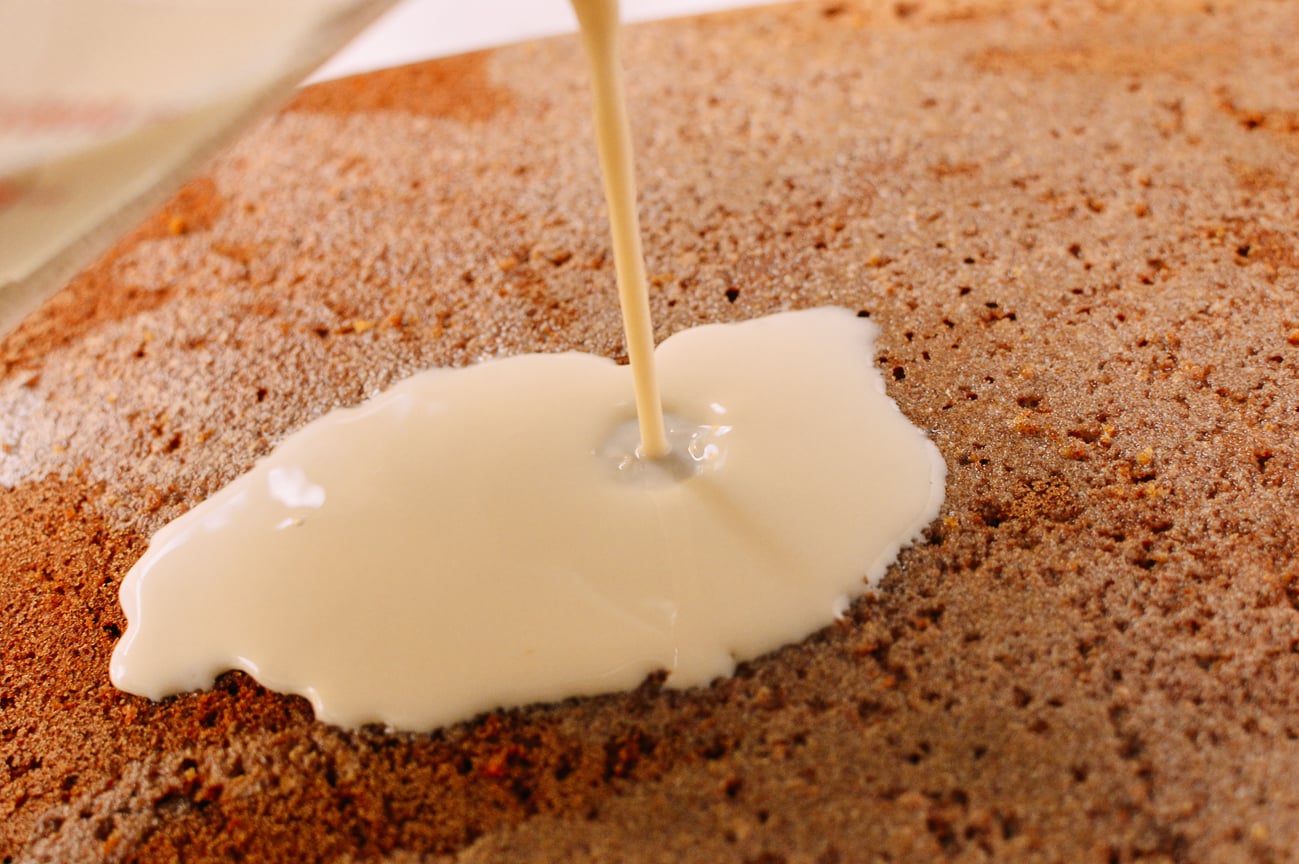 Pouring milk onto cake