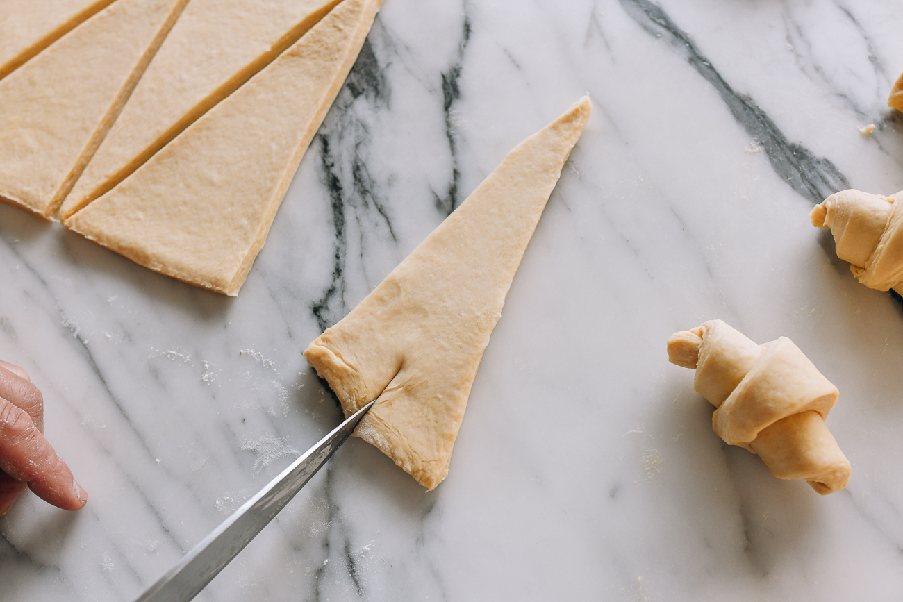 Slicing into base of dough triangle