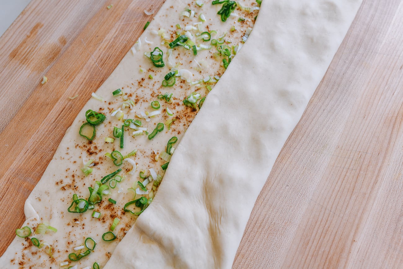 rolling a third of dough into the middle
