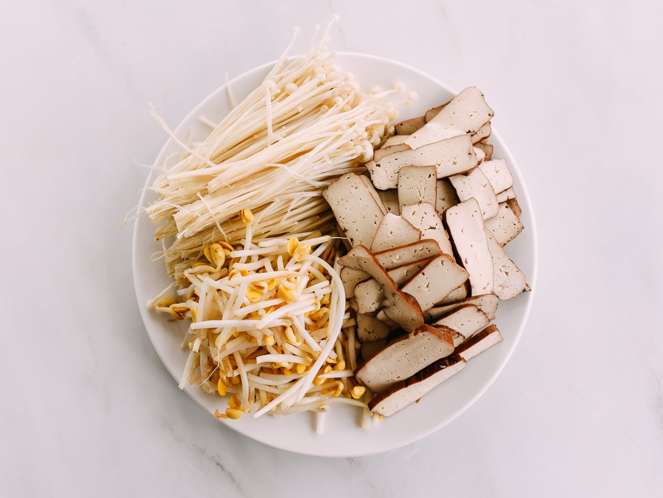 Plate with enoki, soybean sprouts, and sliced pressed tofu