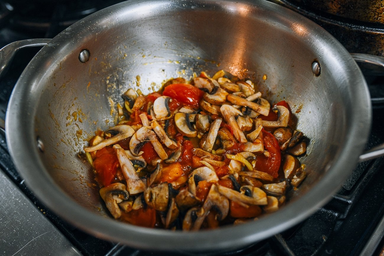 Adding mushrooms to soup pot