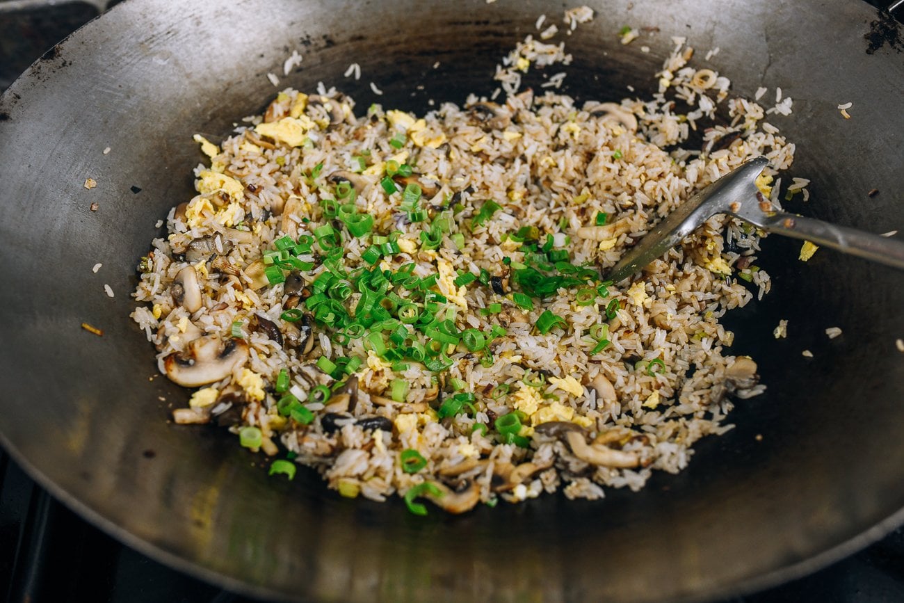 adding scallion to fried rice