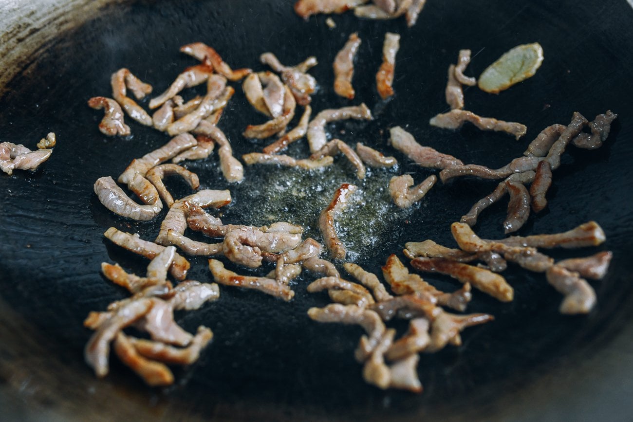 seared pork in wok