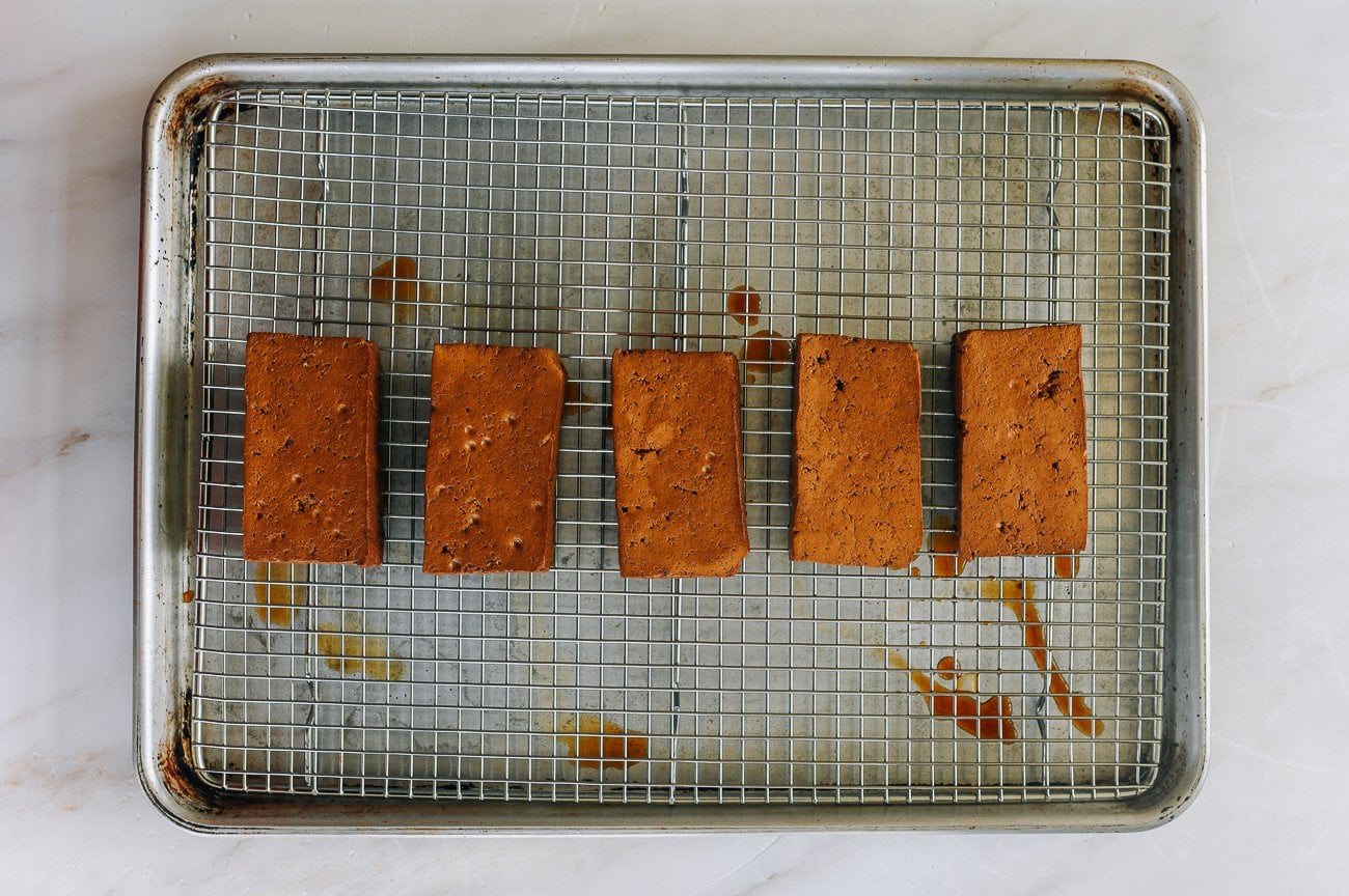 braised tofu pieces on rack on baking sheet