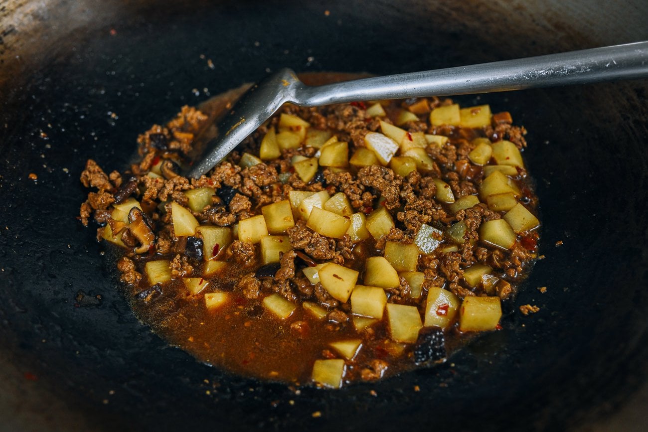 bean paste, pork, and potato mixture stirred together 