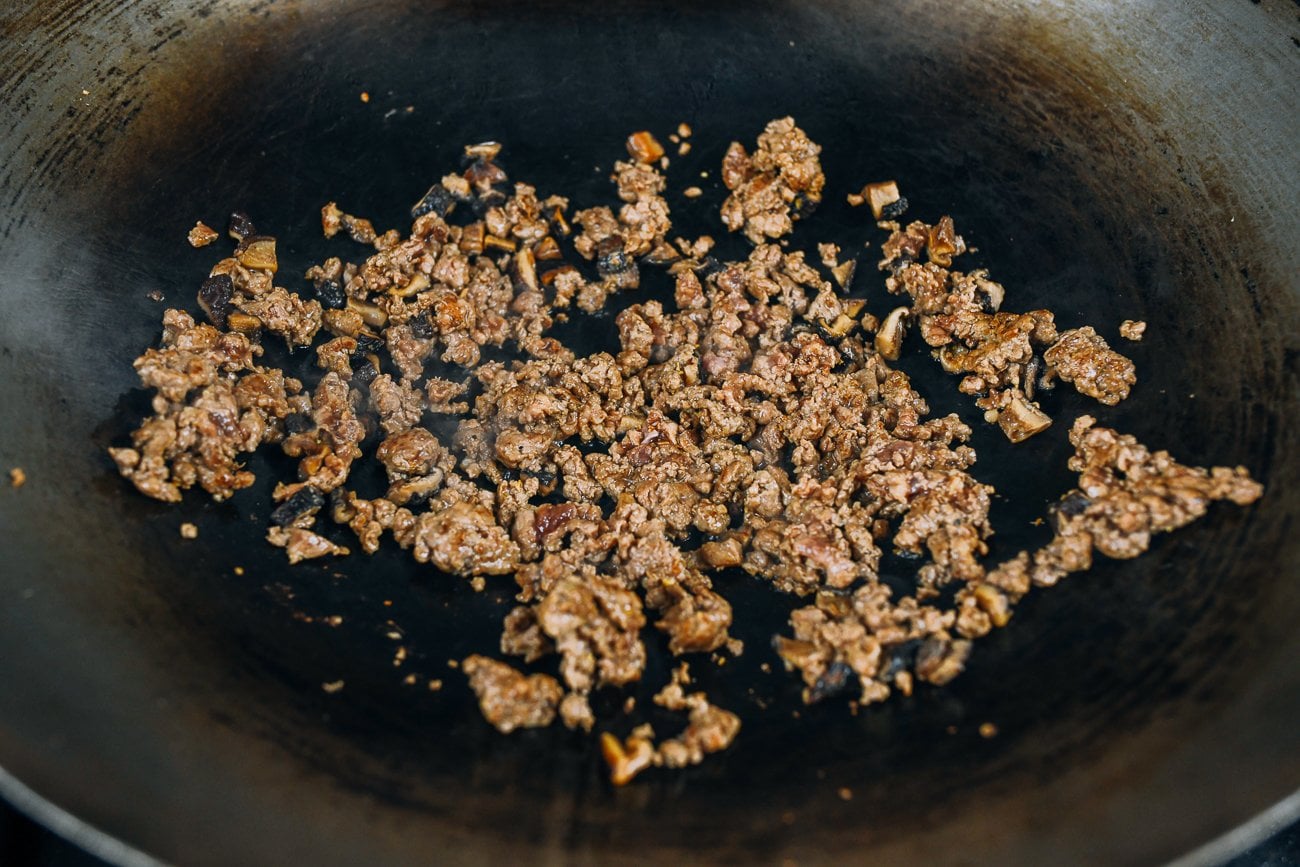 Wok with mixed minced cooked pork and shiitake mushrooms