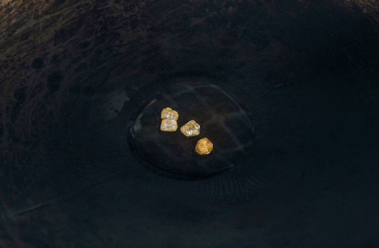 lumps of rock sugar in oil in wok