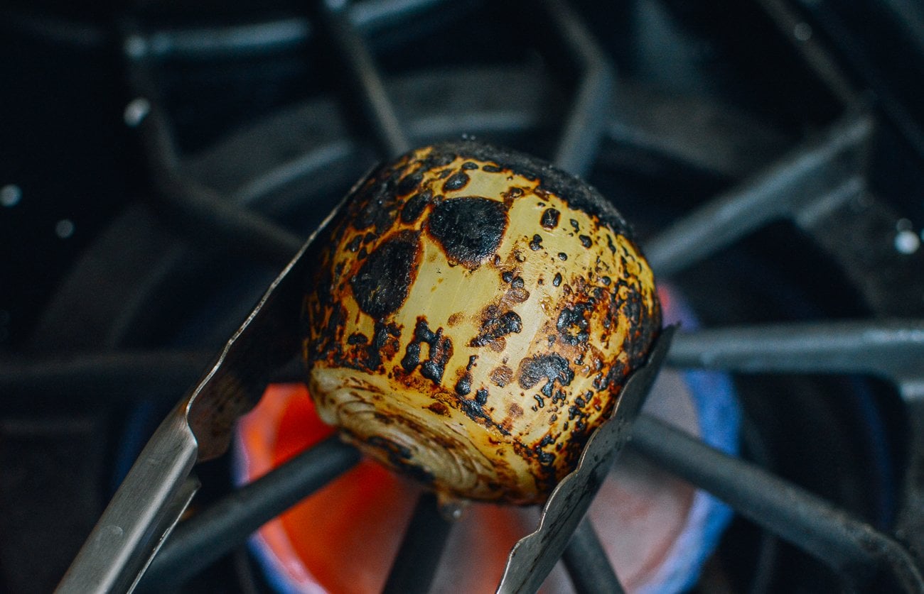 charring onion over the stove
