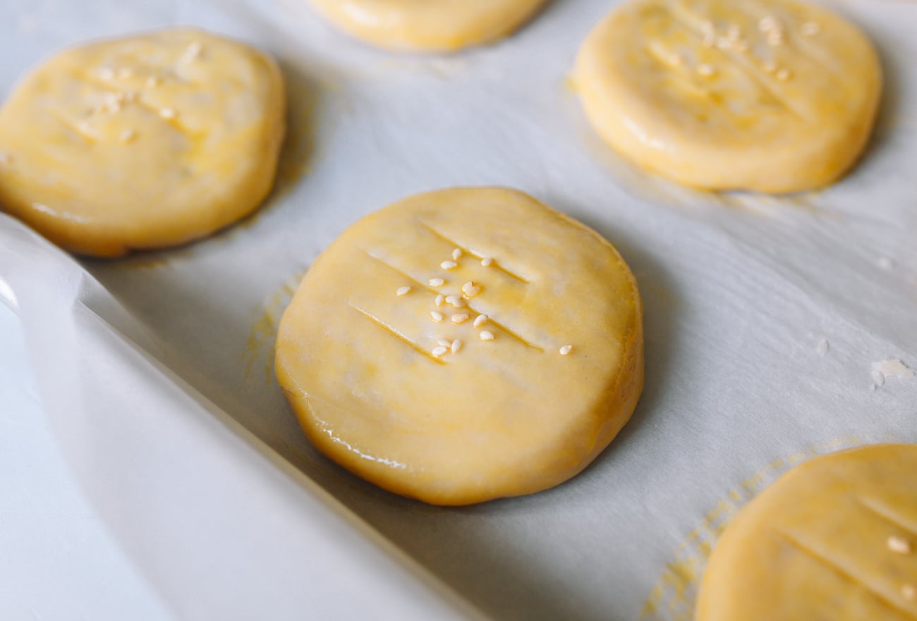 wife cake (lao po bing) before baking, brushed with egg wash and sprinkled with sesame seeds