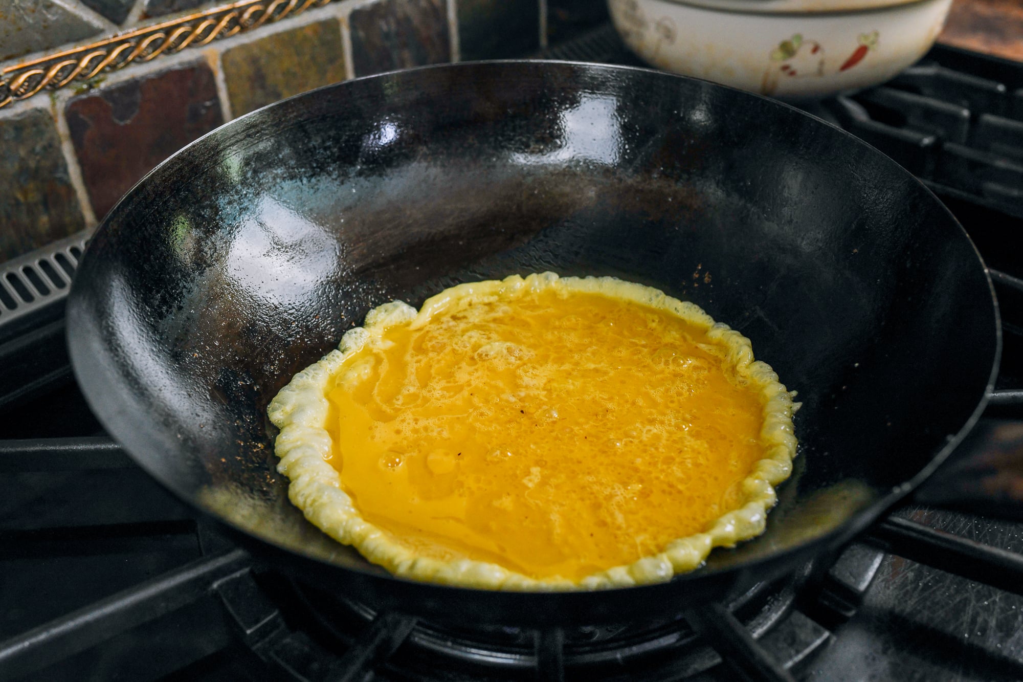 beaten egg poured into hot wok