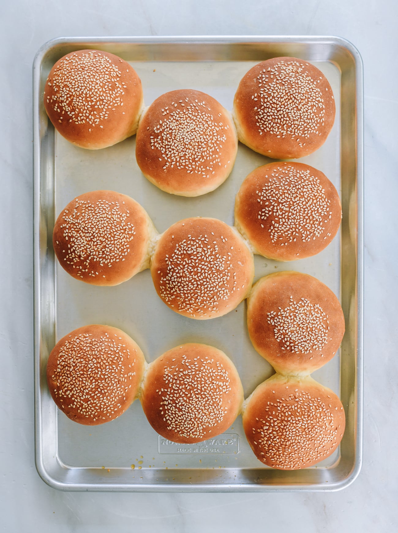 ten hamburger buns on baking sheet