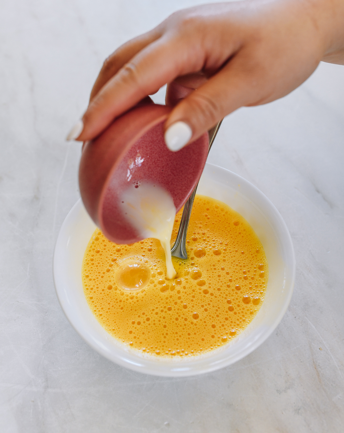 pouring cornstarch slurry into eggs