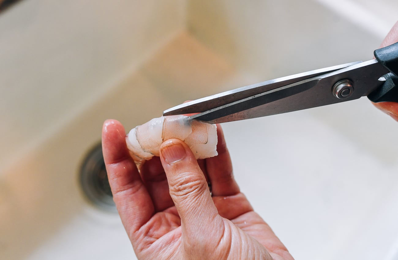 cutting open back of shrimp to expose vein