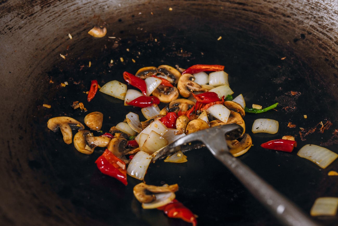 stir-frying onions, mushrooms and peppers