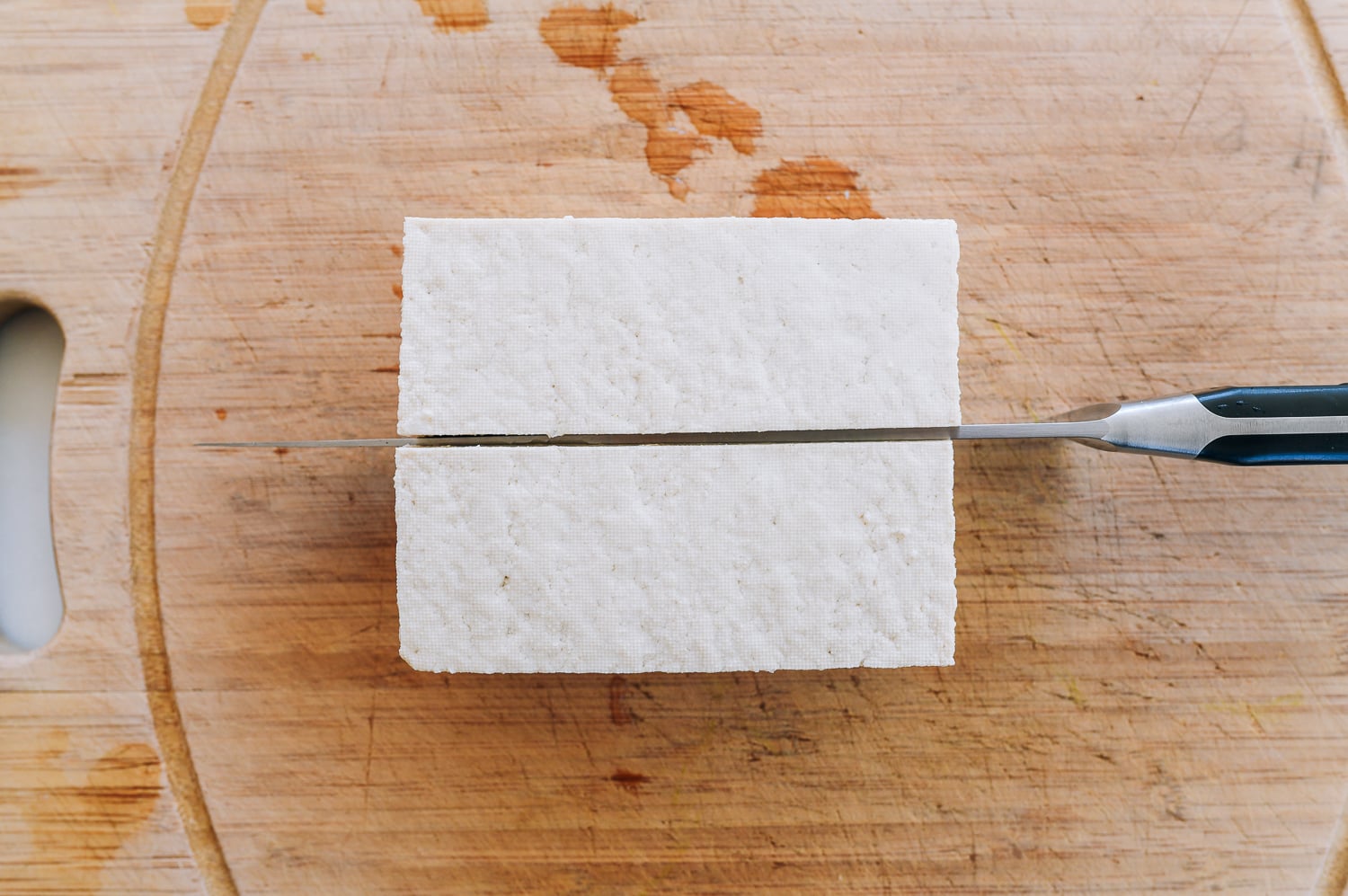 slicing block of tofu in half lengthwise