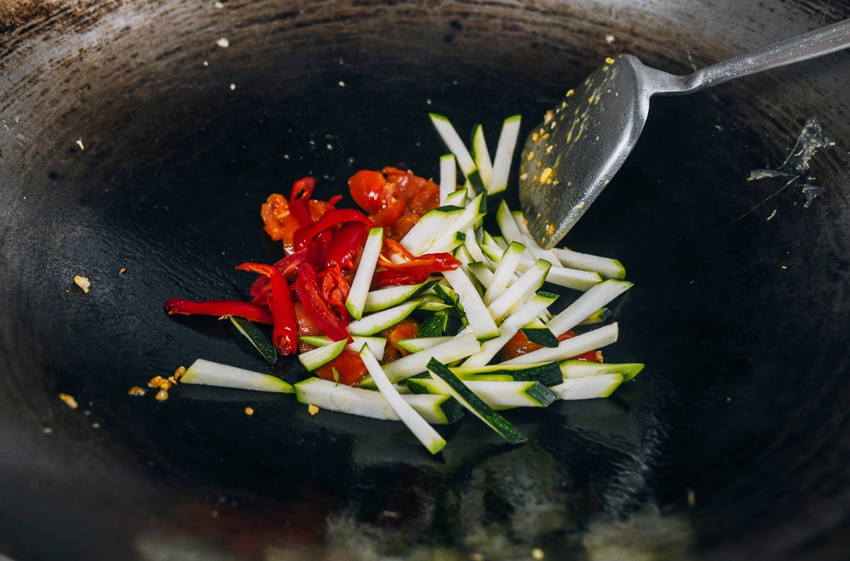 zucchini, tomato, chili, and garlic in wok