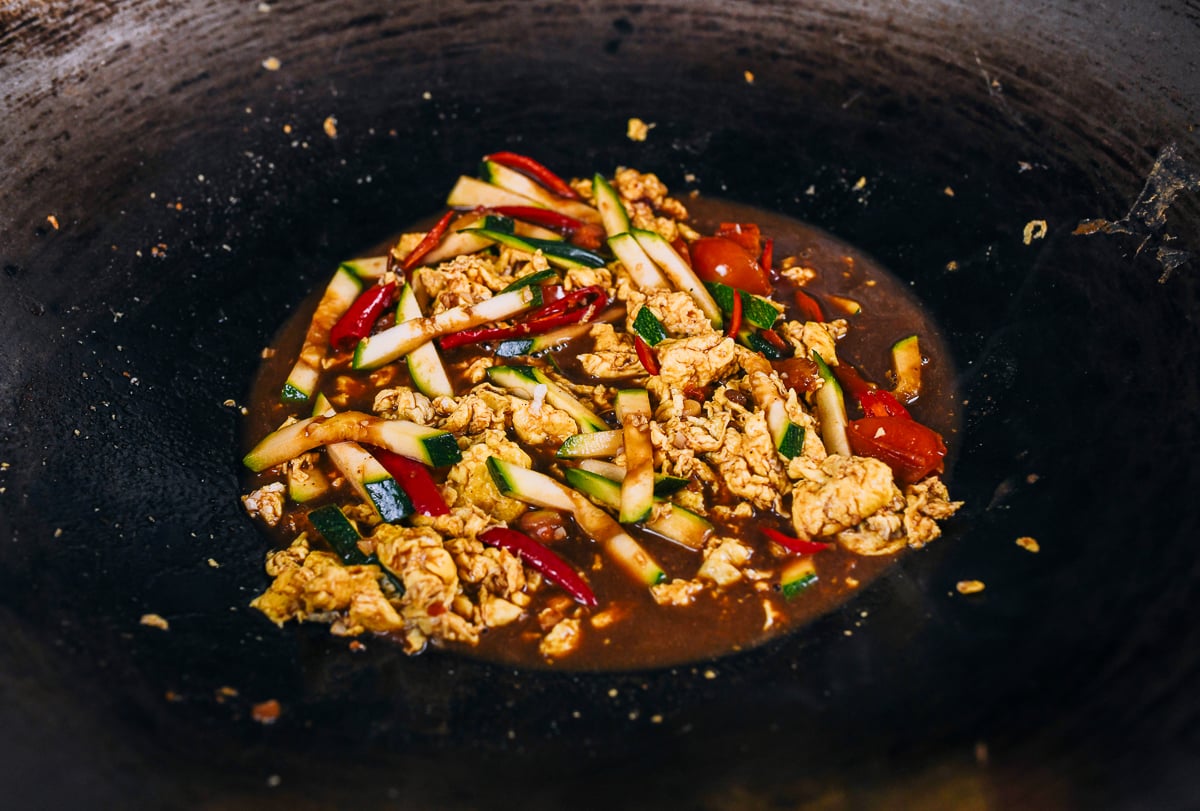 eggs and vegetables with sauce in wok