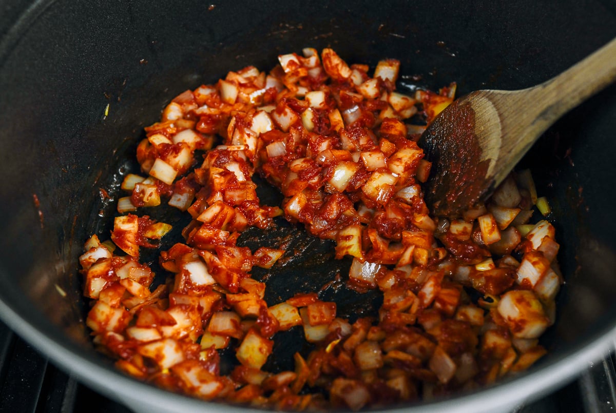 tomato paste and onion in pot