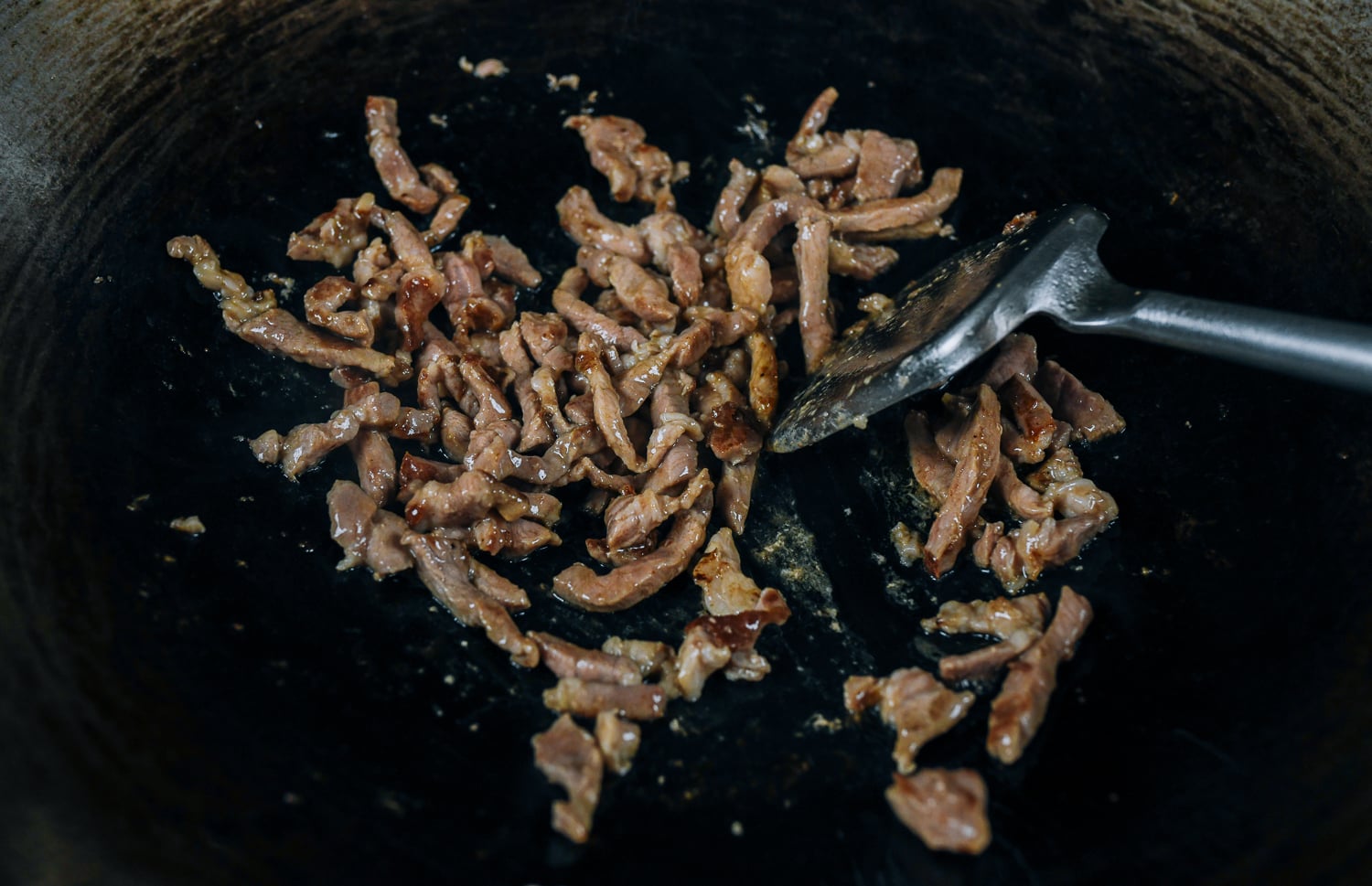 seared pork in wok