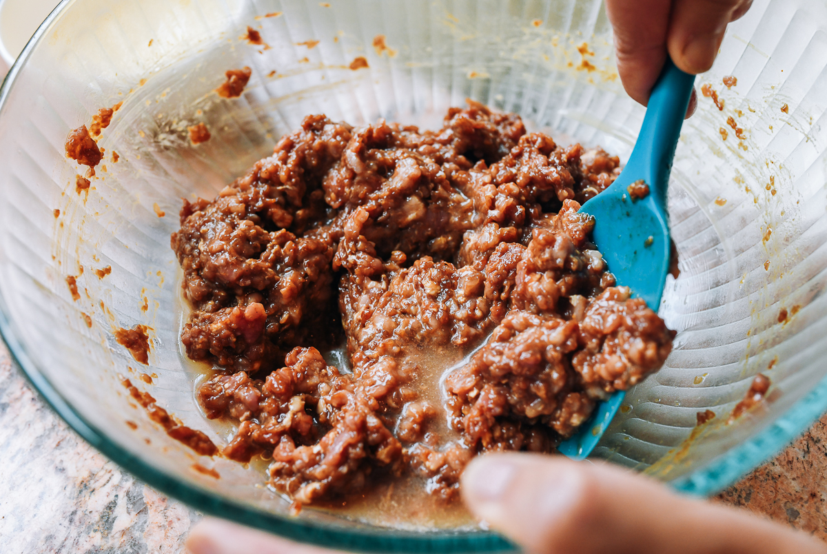 adding infused water to dumpling filling