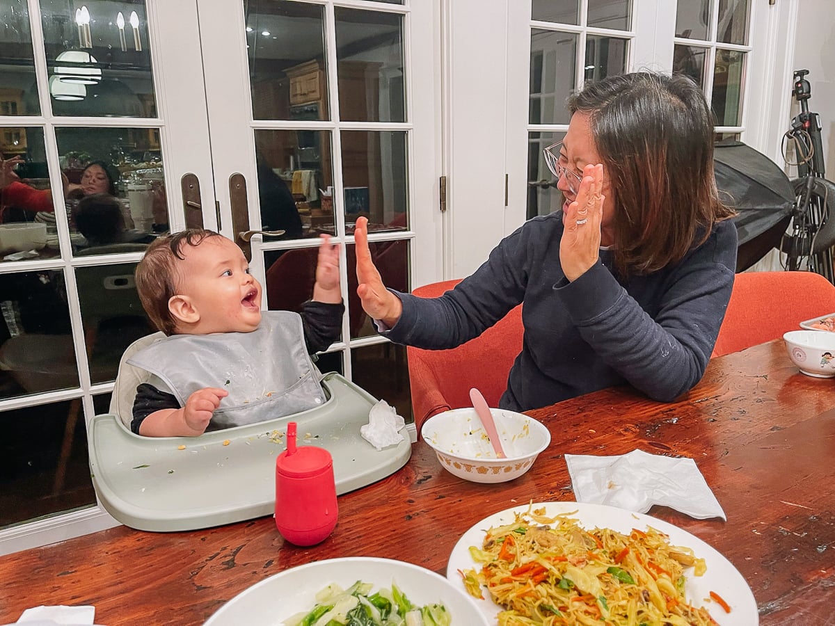 Ethan high fiving grandma at dinner table