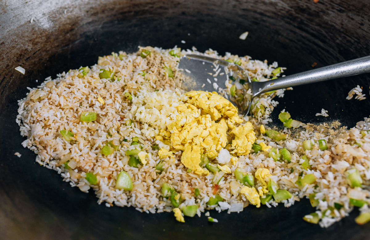 adding eggs to fried rice