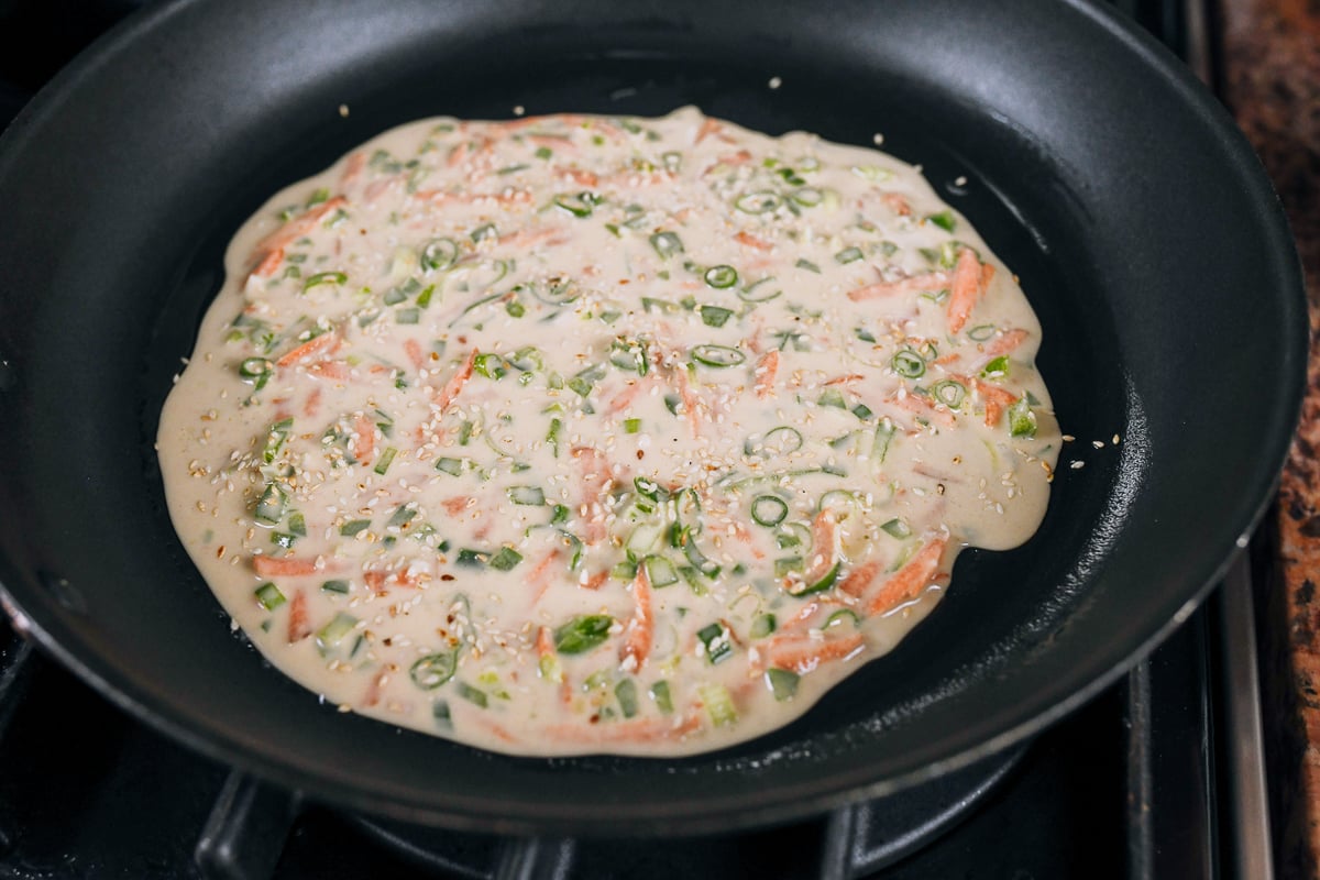 thin vegetable pancake in pan