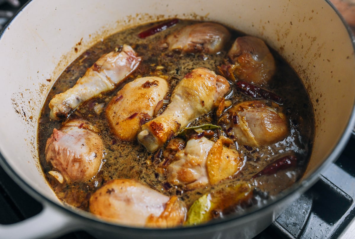 chicken drumsticks added to braising sauce