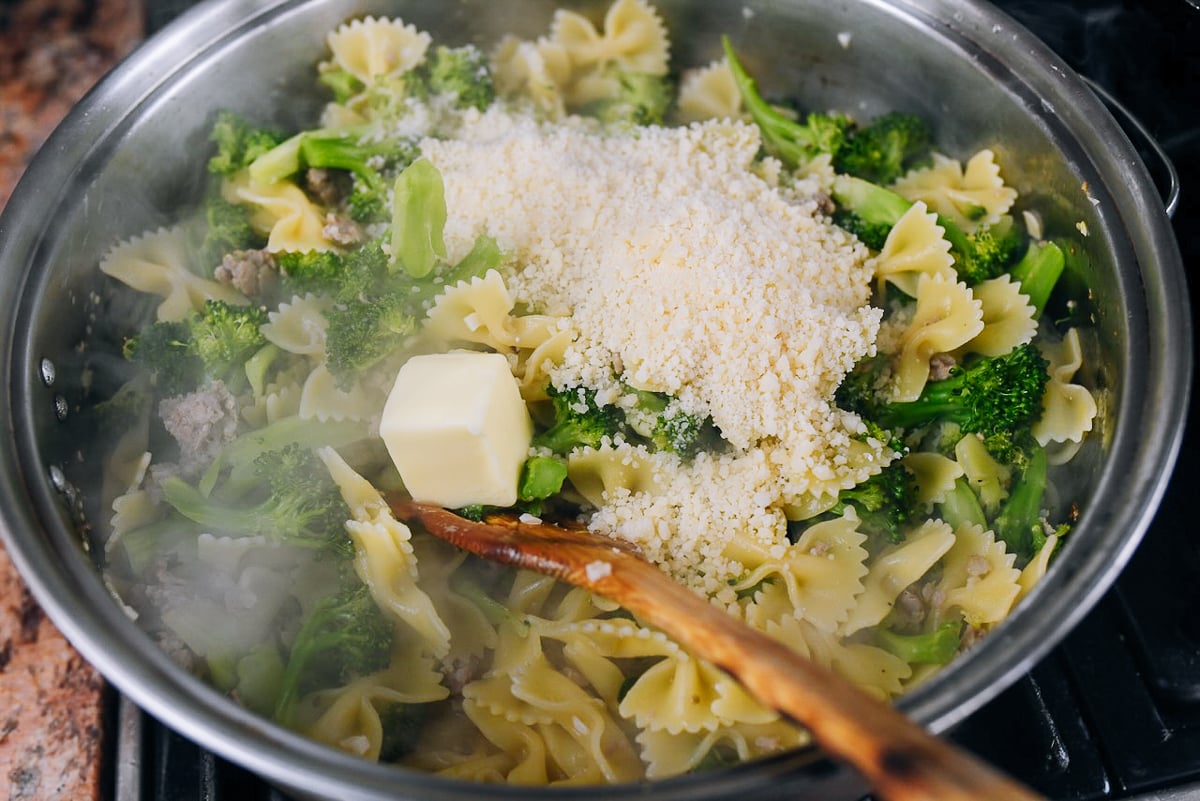 grated parmesan and butter added to pasta and broccoli