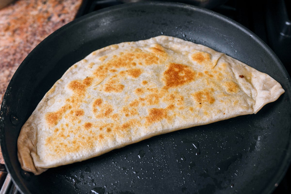 golden brown chive egg pocket in pan